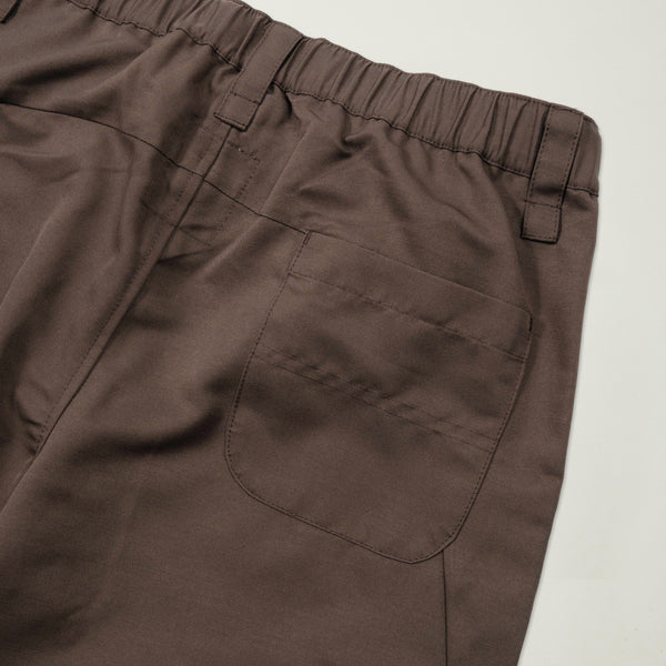 Brown pants with a pocket on a light beige background