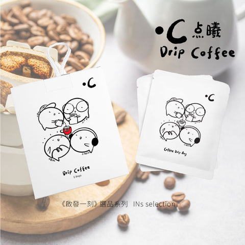 Drip coffee bags with cartoon designs on a wooden coaster with coffee beans and a cup in the background.