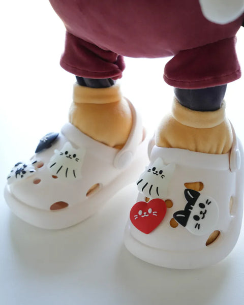Children's white shoes with cartoon designs on a white background