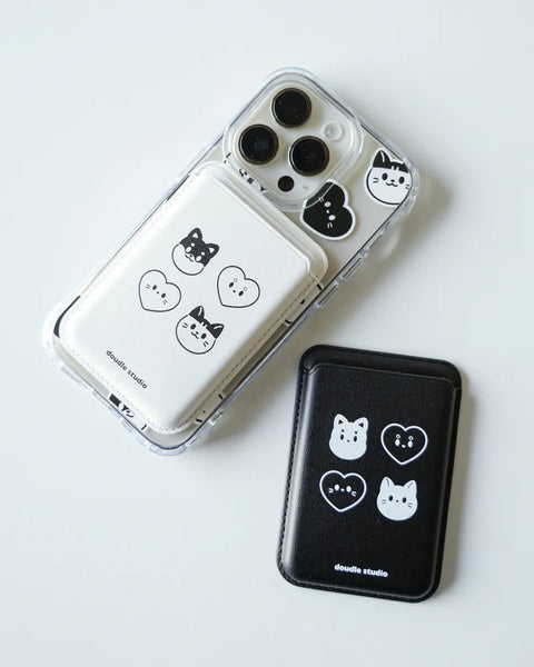 Phone cases with cat and heart designs on a white background