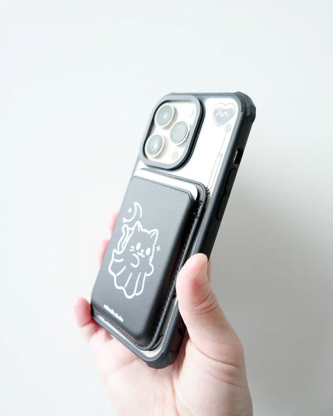 Phone case with a cat design held by a hand against a light gray background