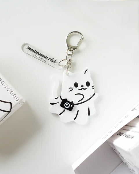Keychain with a cartoon cat design on a white surface
