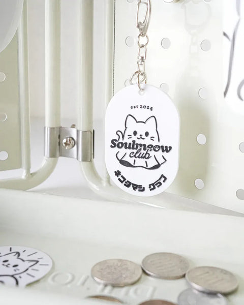 Keychain with 'Soulmeow club' design on a white background
