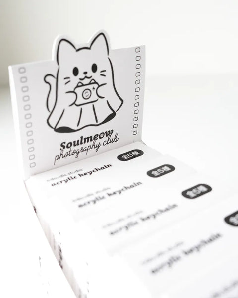 Acrylic keychain packaging with a cartoon cat design and text on a white background