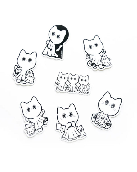 Set of black and white cat-themed stickers on a white background