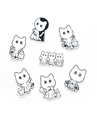 Set of black and white cat-themed stickers on a white background