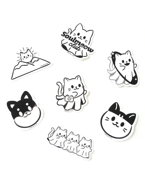 Set of black and white cat-themed stickers on a white background