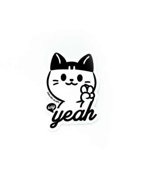 Sticker of a cat with a bow and 'say yeah' text on a white background