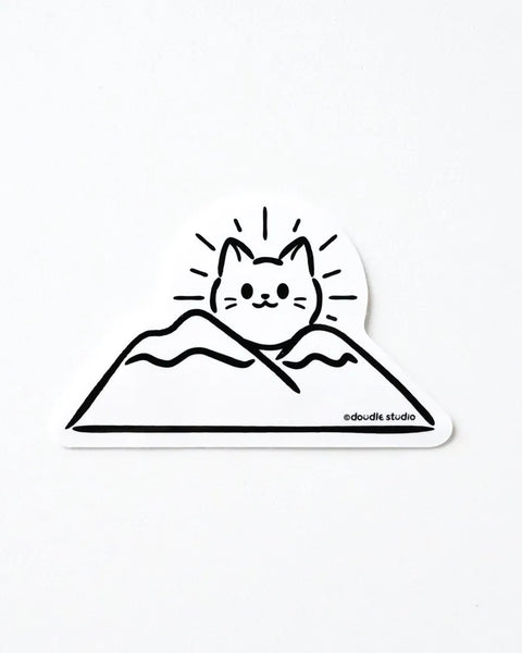 Sticker design of a cat on a mountain with 'edoodle studio' branding.