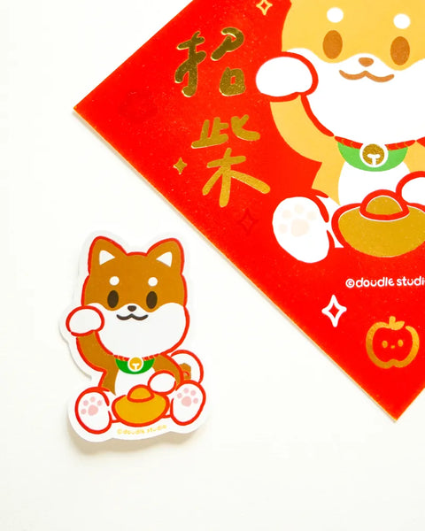 Sticker of a dog character on a red envelope with gold text, featuring the brand 'double studio'.