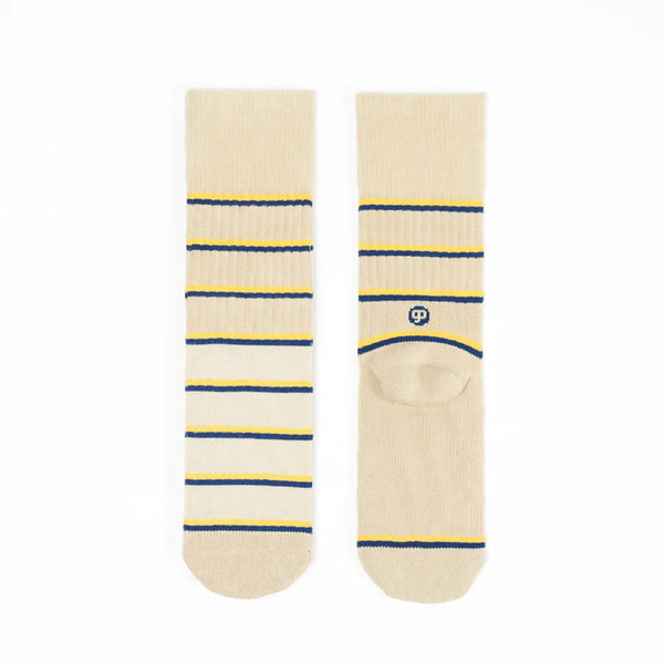 Pair of beige socks with blue and yellow stripes on a white background