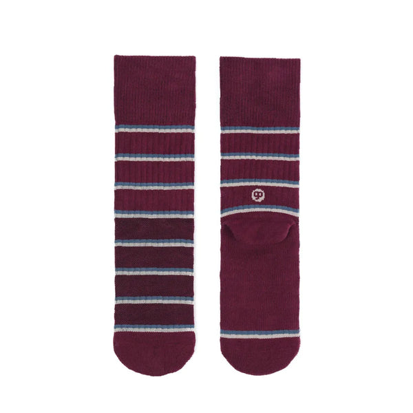 Pair of maroon socks with blue and gray stripes on a white background