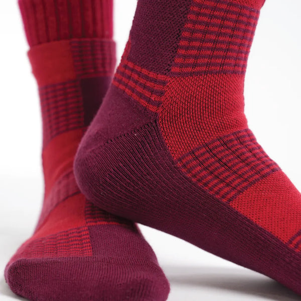 Red and burgundy checkered socks on a white background