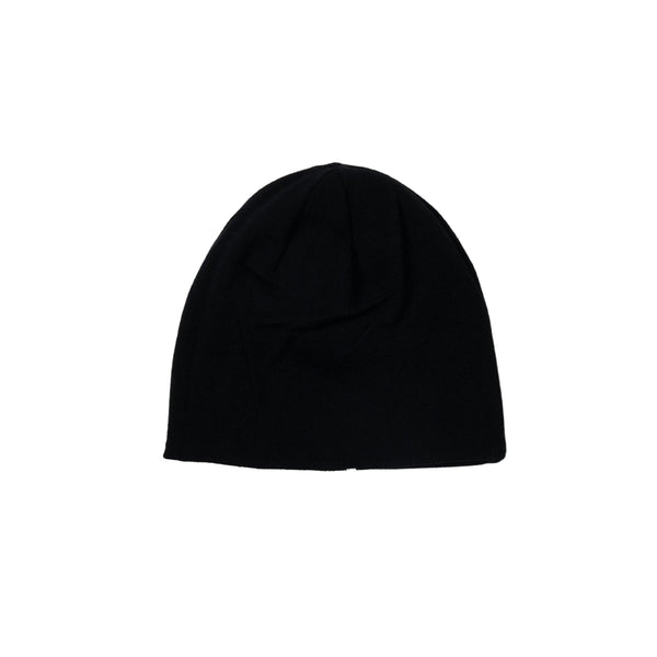 Black beanie on a light beige background