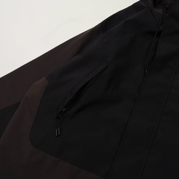 Close-up of a black jacket with a zipper on a light gray background