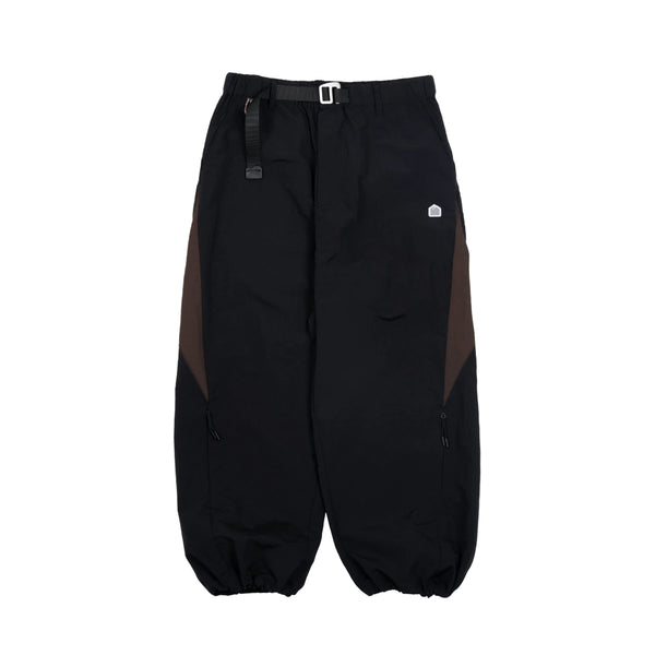 Black pants with a small logo on a light gray background