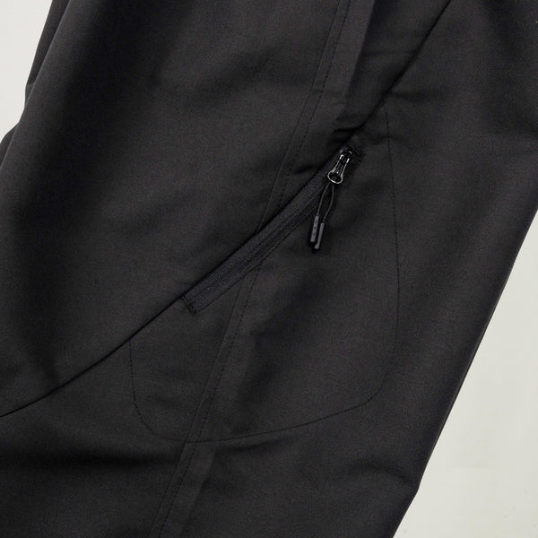 Close-up of a black jacket with a zipper on a light gray background
