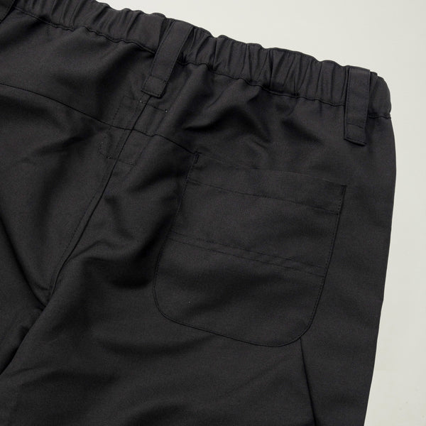 Close-up of black pants with a pocket on a light gray background