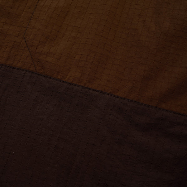Close-up of brown fabric with a visible seam