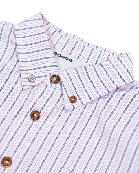 Close-up of a striped shirt with buttons and a brand label on a white background