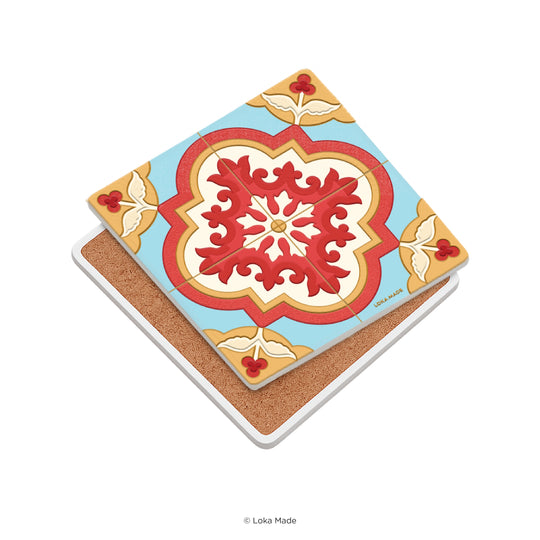 Decorative tile with a red and gold central design on a blue background, featuring a cork backing.