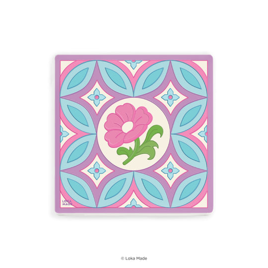 Decorative tile with pink flower and green lizard design on a white background