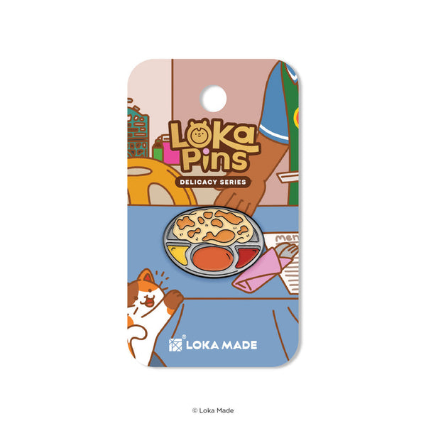 Loka Pins Delicacy Series pin on a colorful card with cartoon illustrations