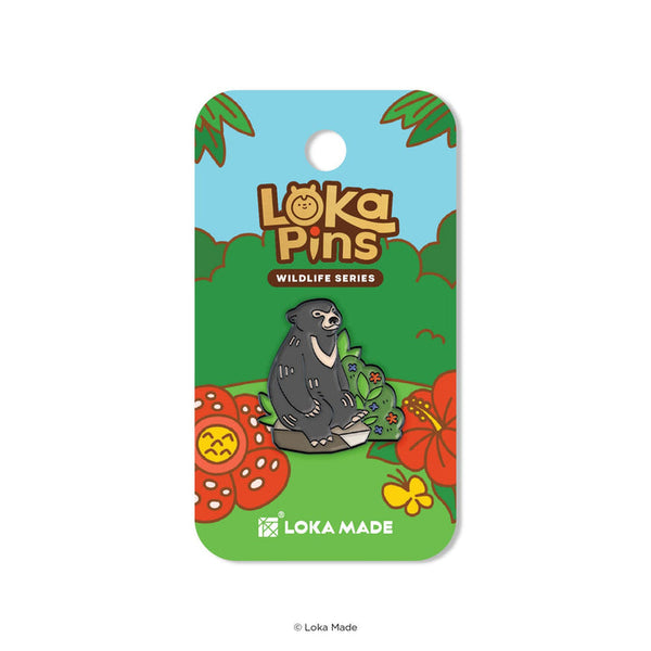 Loka Pins wildlife series pin on a colorful card with flowers and leaves