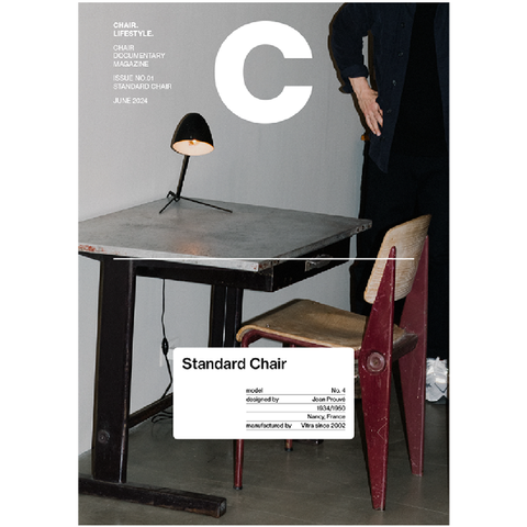 Magazine cover with a table, lamp, and chair, featuring the letter 'C' and text.