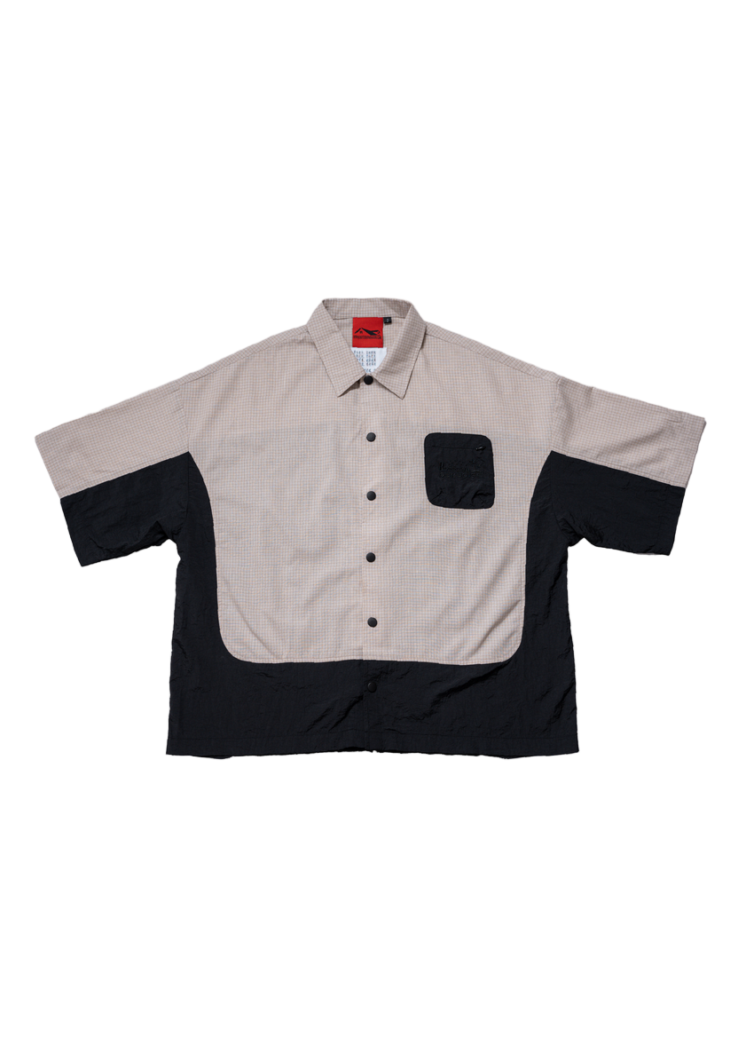 Two-tone shirt with beige and black design on a white background
