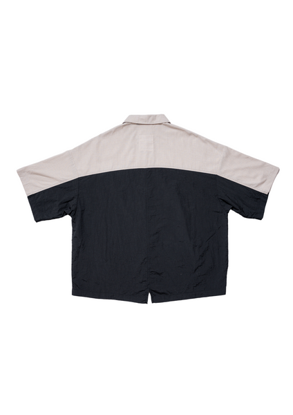 Back view of a two-tone shirt with beige collar and sleeves and black body on a white background