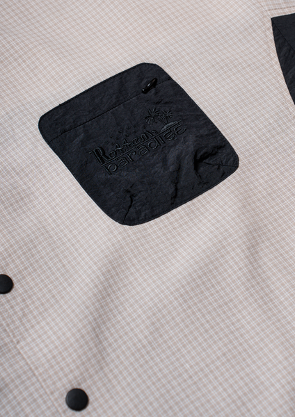 Black pouch with a brand logo on a textured gray surface