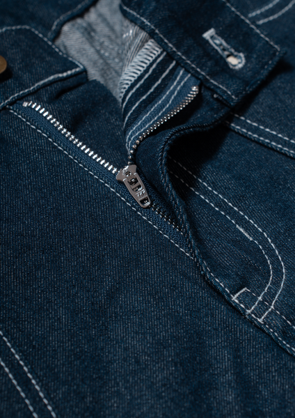 Close-up of a blue denim jacket zipper
