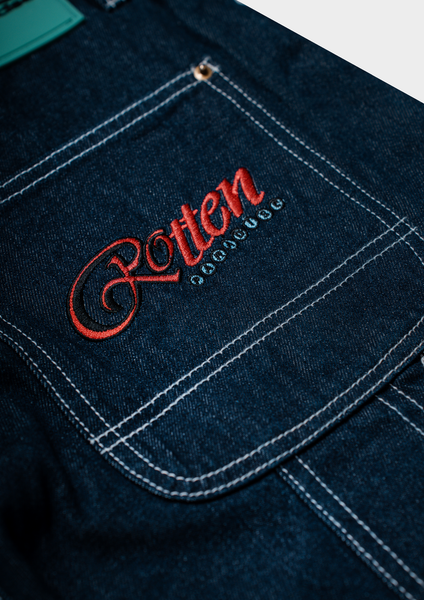 Embroidered logo on a dark denim fabric with red lettering