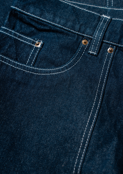 Close-up of blue denim fabric with stitching details