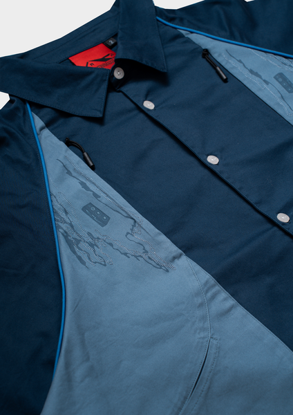 Close-up of a blue jacket with a brand logo on a white background