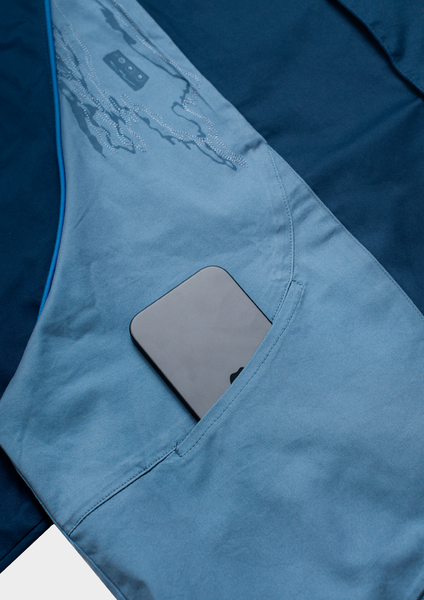 Blue jacket with a pocket containing a smartphone