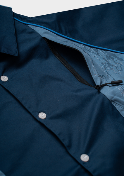 Close-up of a navy blue jacket with buttons and a zipper on a light gray background