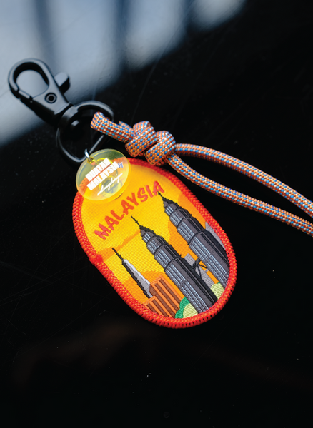 Keychain with Malaysia design featuring the Petronas Towers on a dark background