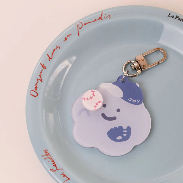 Keychain with a cartoon character on a light blue plate