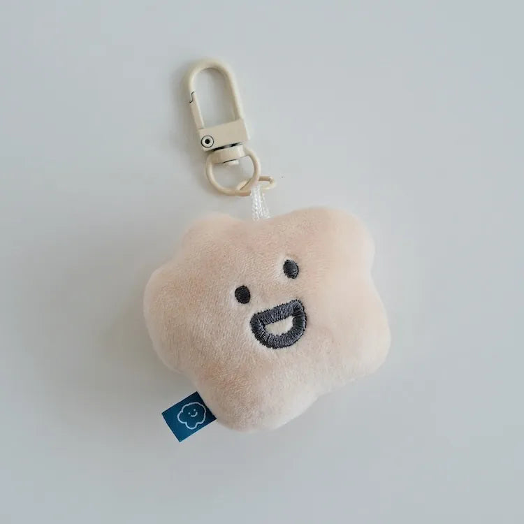 Plush cloud-shaped keychain with a smiling face on a light gray background