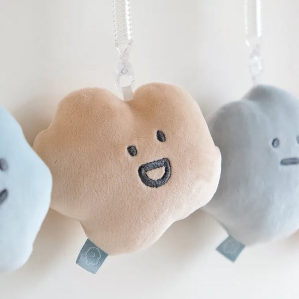 Heart-shaped plush toys with smiling faces on a white background