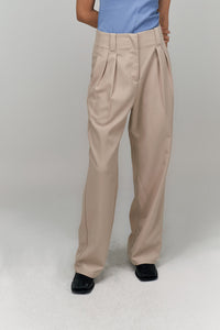 THE WES STUDIO Classic Medium Rise Forward Pleated Trousers: Beige